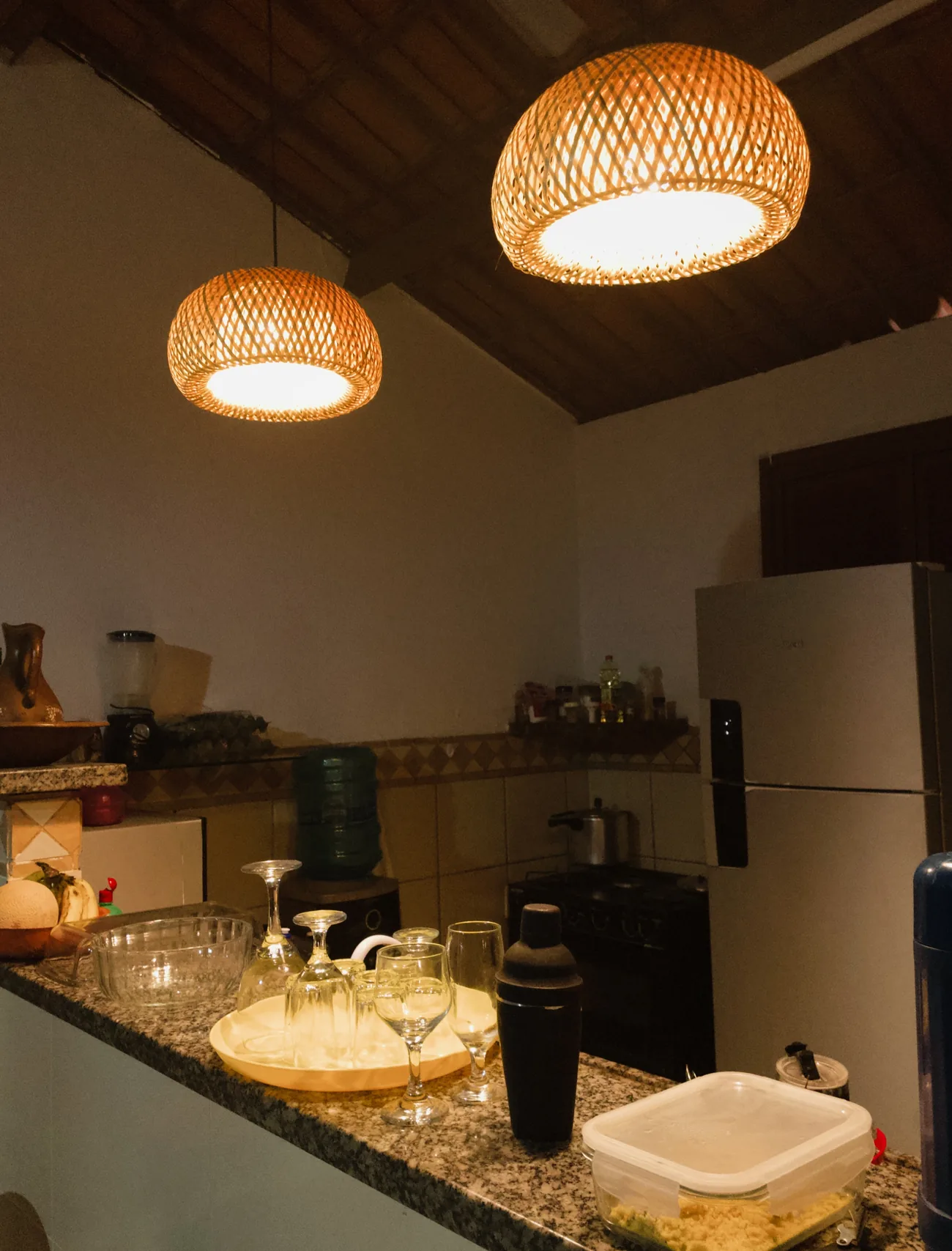 Detalhe da luminária de fibra natural sobre a bancada da cozinha